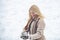 Happy woman winter portrait. Snowball fight. Woman holding the snowball in hands. Beauty Winter Girl in frosty winter