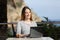 Happy woman working with her laptop in an hotel terrace