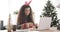 Happy woman wrapping Christmas gift at office