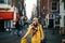 Happy woman in yellow coat in Amsterdam