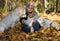 The Happy Woman with Yellow Labradors in the Autumn Park In the sunny day