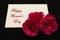 Happy Womans Day March 8th written on white card with red roses