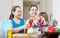 Happy women with baby in kitchen