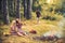 Happy women with blurred man in summer forest. Fashion women in retro dresses relax at bonfire. Beauty girls with long