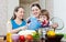 Happy women with child together cooking veggie lunch