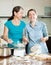 Happy women cooking dumplings