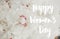 Happy Women`s day text handwritten on lovely peony bouquet close up on white wall background. Stylish white peonies with red