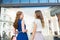 Happy women with shopping bags at storefront