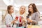 Happy women with smartphones and shopping bags