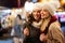 Happy women talking and laughing outdoor in city at Christmas. Happiness shopping people concept