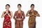 Happy women in traditional clothing showing greeting gestures. Conceptual image