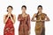 Happy women in traditional clothing showing greeting gestures. Conceptual image