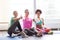 Happy women with water showing thumbs up in gym