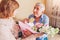 Happy Womens Day, 8 March gift. Senior man gifting his wife bouquet of flowers at home. Woman reads greeting card