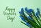 HAPPY WOMENS DAY Postcard layout. Spring modern still life. Blue muscari flowers growing from rectangular cut in paper on blue