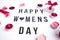 Happy womens day text on white table background, with gift boxes and candles