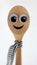 Happy wooden spoon with big eyes.