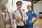 Happy workers of the airline company standing in a hangar