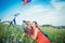 Happy young adult couple in love on the field. Two, man and woman have picnic, smiling and resting on the green grass.