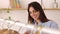 Happy young adult female owner checking stock at clothing store