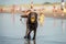 Happy young adult labrador playing with yellow ball at the beach