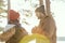 Happy young affectionate couple in warm winterwear having hot tea outside