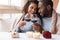 Happy young African American couple drinking wine in the restaurant