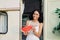 Happy young african american woman is holding slice of watermelon