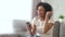 Happy young african american woman winner screaming looking at smartphone