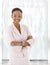 Happy young afro-american woman in office lobby