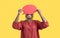 Happy young anonymous black woman hiding her face behind blank red speech bubble