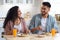 Happy young arab couple enjoying eating their breakfast together