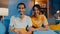 Happy young asia couple man and woman looking at camera smile and cheerful on video call online at night in living room at home,