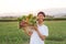 Happy young asian farmer carrying fresh product of vegetable basket