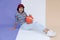 Happy young asian girl palying basketball with pastel background