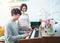 Happy young asian pregnant woman stand side of man play piano at home. Pregnancy, motherhood, people, love, expectation, family -