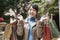 Happy young asian woman carrying shopping bags smiling