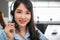 Happy young asian woman customer service support or business call center wears headset smile sitting working and consulting