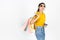Happy young Asian woman holding colorful shopping bag over white isolated background. Lifestyle, Consumerism, Sale and Shopping