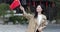 happy young asian woman holding hand Chinese National Flag outdoor. Person celebrating National Day October 1th or