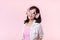 happy young asian woman model with stylish trendy sun glasses enjoy listening music by headphone audio and dancing isolated on