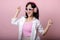 happy young asian woman model with stylish trendy sun glasses enjoy listening music by headphone audio and dancing isolated on