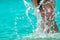 Happy young Asian woman in pink swimsuit relax and enjoy holiday at tropical paradise beach. Girl in summer vacation splash water