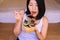 Happy young asian woman using fork eating breakfast salad for healthy,Selective focus