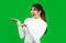 Happy Young Asian woman wearing white shirt posing like show something on green screen