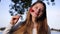 Happy young attractive girl with red heart on stick