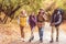 Happy young backpackers in forest