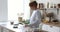 Happy young baker woman enjoying cooking hobby in home kitchen