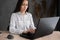 Happy young beautiful woman using laptop, indoors. girl typing on the computer. Female teleworker texting using laptop