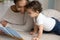 Happy young biracial mother and little toddler reading book